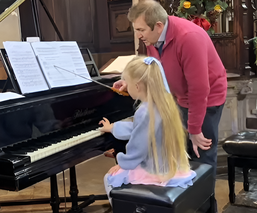 Happy child playing piano