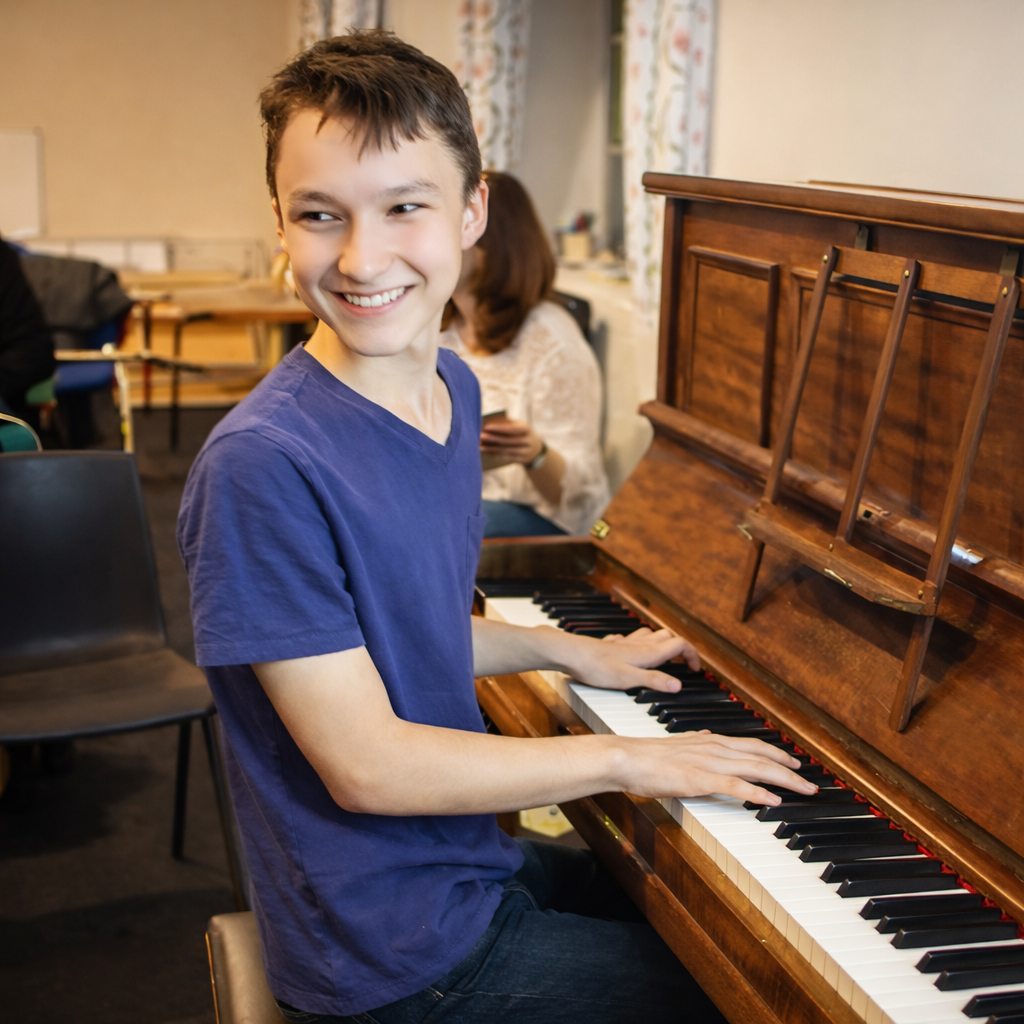 Happy child playing piano